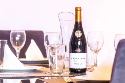 a bottle of wine sitting on a table with glasses at Maria Casa Branca by ALMA Holiday Rentals in Funchal