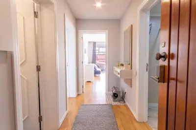 a hallway with white walls and wooden floors at Maria Casa Branca by ALMA Holiday Rentals in Funchal