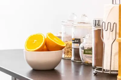 a bowl of oranges on a counter with other ingredients at Maria Casa Branca by ALMA Holiday Rentals in Funchal