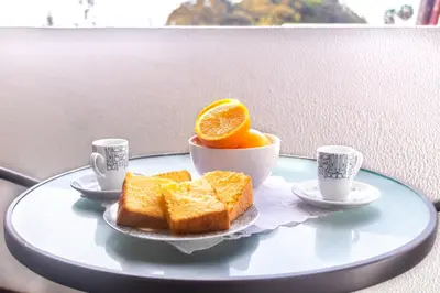 a plate of bread and orange slices on a table at Maria Casa Branca by ALMA Holiday Rentals in Funchal