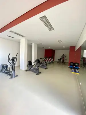 a gym with bikes and exercise equipment in a room at Concordia Apartment in Funchal