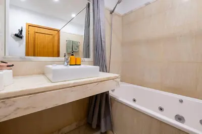 a bathroom with a sink and a bath tub at Unique Two-Patios - Stylish Stay by Pico Fortress in Funchal