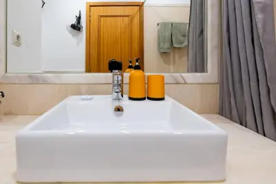a bathroom sink with two bottles on top of it at Unique Two-Patios - Stylish Stay by Pico Fortress in Funchal