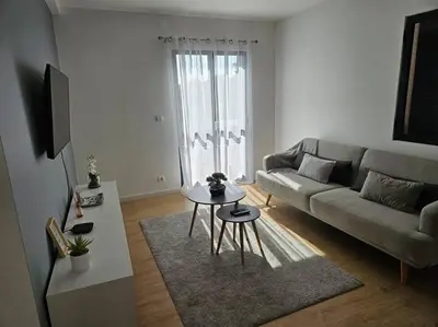 a living room with a couch and a table at Pedreira apartment in Calheta