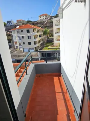 a balcony with a view of a city at Pedreira apartment in Calheta