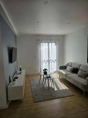 a living room with a couch and a table at Pedreira apartment in Calheta