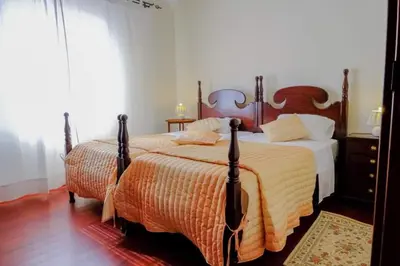 a bedroom with a large bed and a mirror at Granny's house view in Funchal
