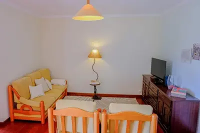 a living room with a couch and a table at Granny's house view in Funchal