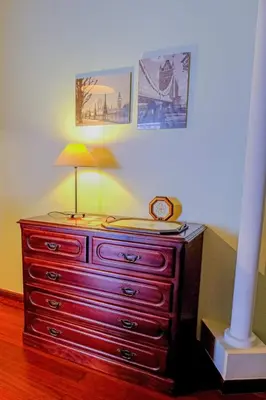 a red dresser with a lamp on top of it at Granny's house view in Funchal