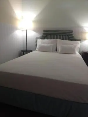 a large white bed with two pillows on it at Granny's house view in Funchal