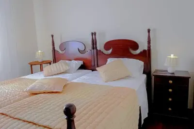 a bedroom with a large bed with two pillows at Granny's house view in Funchal