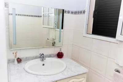 a bathroom with a sink and a mirror at Benoni House by Stay Madeira Island in Ponta do Sol