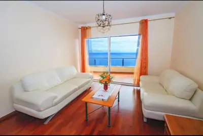 a living room with two white couches and a window at Benoni House by Stay Madeira Island in Ponta do Sol