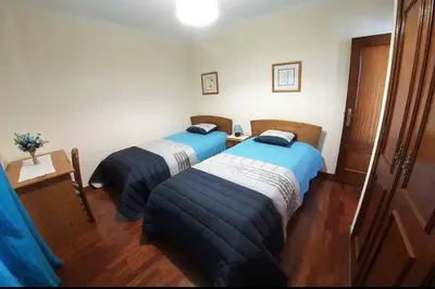 two beds in a hotel room with blue and white sheets at Benoni House by Stay Madeira Island in Ponta do Sol