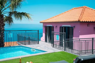 a villa with a swimming pool and a view of the ocean at Villa Rosa with private pool by Holiday Rental Madeira in Ribeira Brava