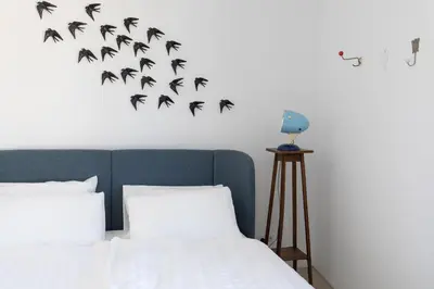 a bedroom with a heart made of bats on the wall at Moinho Calmo in Vila do Bispo