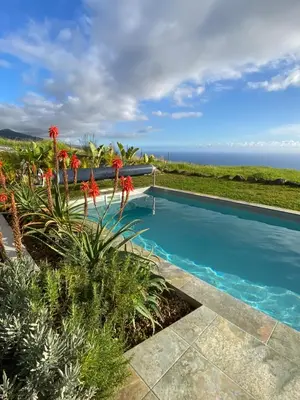 a swimming pool with a view of the ocean at The Hideaway Madeira in Prazeres
