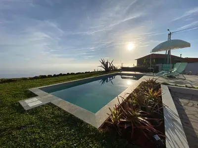 a swimming pool in the yard of a house at The Hideaway Madeira in Prazeres