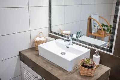 a bathroom with a white sink and a mirror at The Hideaway Madeira in Prazeres
