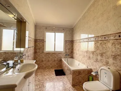 a bathroom with a sink and a tub and a toilet at Vila Feliz in Paul do Mar