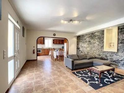 a living room with a couch and a table at Vila Feliz in Paul do Mar