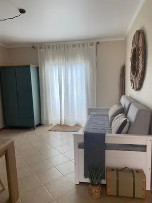 a bedroom with a bed and a large window at Cool Apartment in Porto Santo