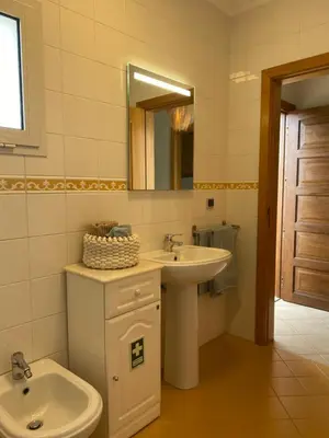 a bathroom with a sink and a toilet and a mirror at Cool Apartment in Porto Santo
