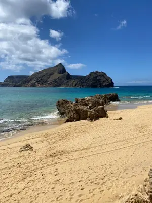 a sandy beach with a mountain in the background at Cool Apartment in Porto Santo