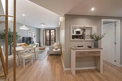 a kitchen and living room with a table and a dining room at The Mountain Apartment by An Island Apart in Funchal