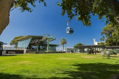 a gondola ride in a park in front of a building at The Mountain Apartment by An Island Apart in Funchal