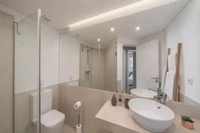 a bathroom with a sink and a toilet and a mirror at The Mountain Apartment by An Island Apart in Funchal