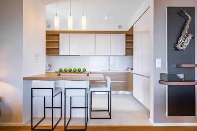 a kitchen with a bar with stools and a musical instrument at Maha by KAAMAH - 2 Bedroom OceanView Designer Apartment in Funchal