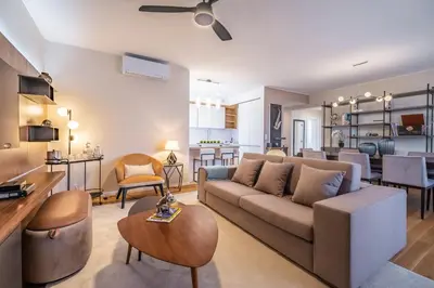 a living room with a couch and a table at Maha by KAAMAH - 2 Bedroom OceanView Designer Apartment in Funchal