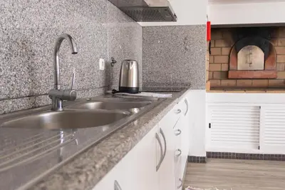 a kitchen with a sink and a counter top at Casa Luz - Arco da Calheta in Arco da Calheta