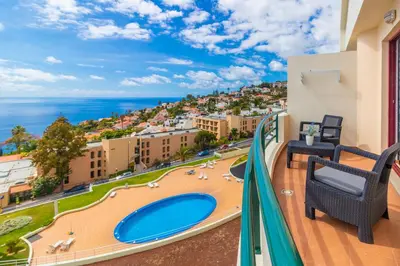 a balcony with a view of the ocean at Calandiva in Caniço