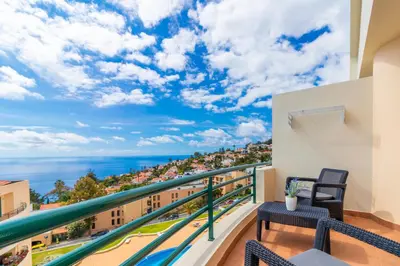 a balcony with a view of the ocean at Calandiva in Caniço