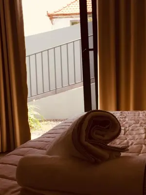 a bed in a bedroom with a view of a balcony at Calheta Ocean View Apartment 2 - Air Condition in Estreito da Calheta