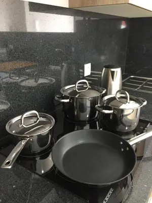four pots and pans on a stove in a kitchen at Calheta Ocean View Apartment 2 - Air Condition in Estreito da Calheta