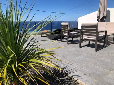 two chairs and a table on a patio at Calheta Ocean View Apartment 2 - Air Condition in Estreito da Calheta