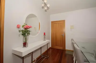 a bathroom with a sink with a vase of flowers at Praia Mar (sea view) by STAY Madeira Island in Ponta do Sol