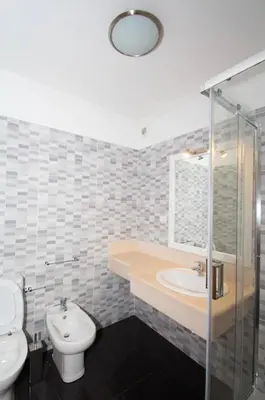 a bathroom with a sink and a toilet and a shower at Praia Mar (sea view) by STAY Madeira Island in Ponta do Sol