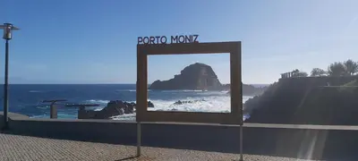 a living room with a couch and a table at The Jolie - Apartments by the Ocean in Porto Moniz