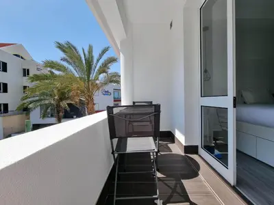 a white bathroom with a toilet and a mirror at The Jolie - Apartments by the Ocean in Porto Moniz