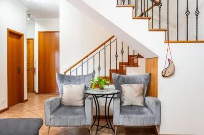 a living room with two chairs and a table at Lobos Flat in Câmara de Lobos