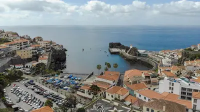 an aerial view of a town with a beach and the ocean at Lobos Flat in Câmara de Lobos