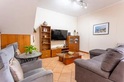 a living room with two couches and a tv at Lobos Flat in Câmara de Lobos