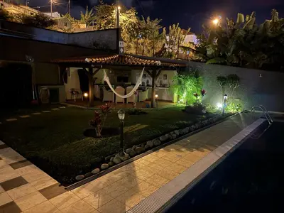 a house with a swimming pool at night at Funchal Apt- Sleeps 2 - Pool & Parking - Madeira in Funchal