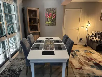 a dining room with a white table and chairs at Funchal Apt- Sleeps 2 - Pool & Parking - Madeira in Funchal