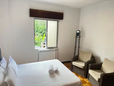 a living room with a couch and a wooden floor at Villa do Monte in Porto Moniz