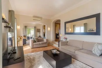 a living room with a couch and a table at Villa Bougainvillea Palheiro Village by Holiday Rental Madeira in Funchal